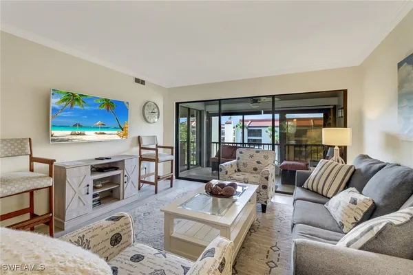 a living room with furniture flat screen tv and a fireplace