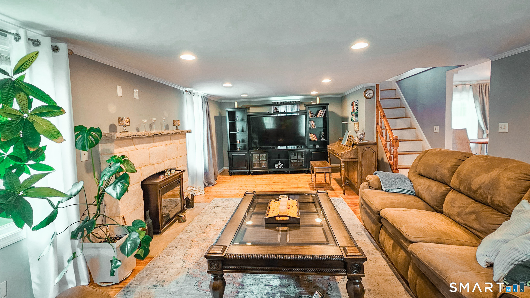 384 Long Hill Road South Windsor, CT 06074 - Photo 11 of 40 a living room with furniture a flat screen tv and a potted plant