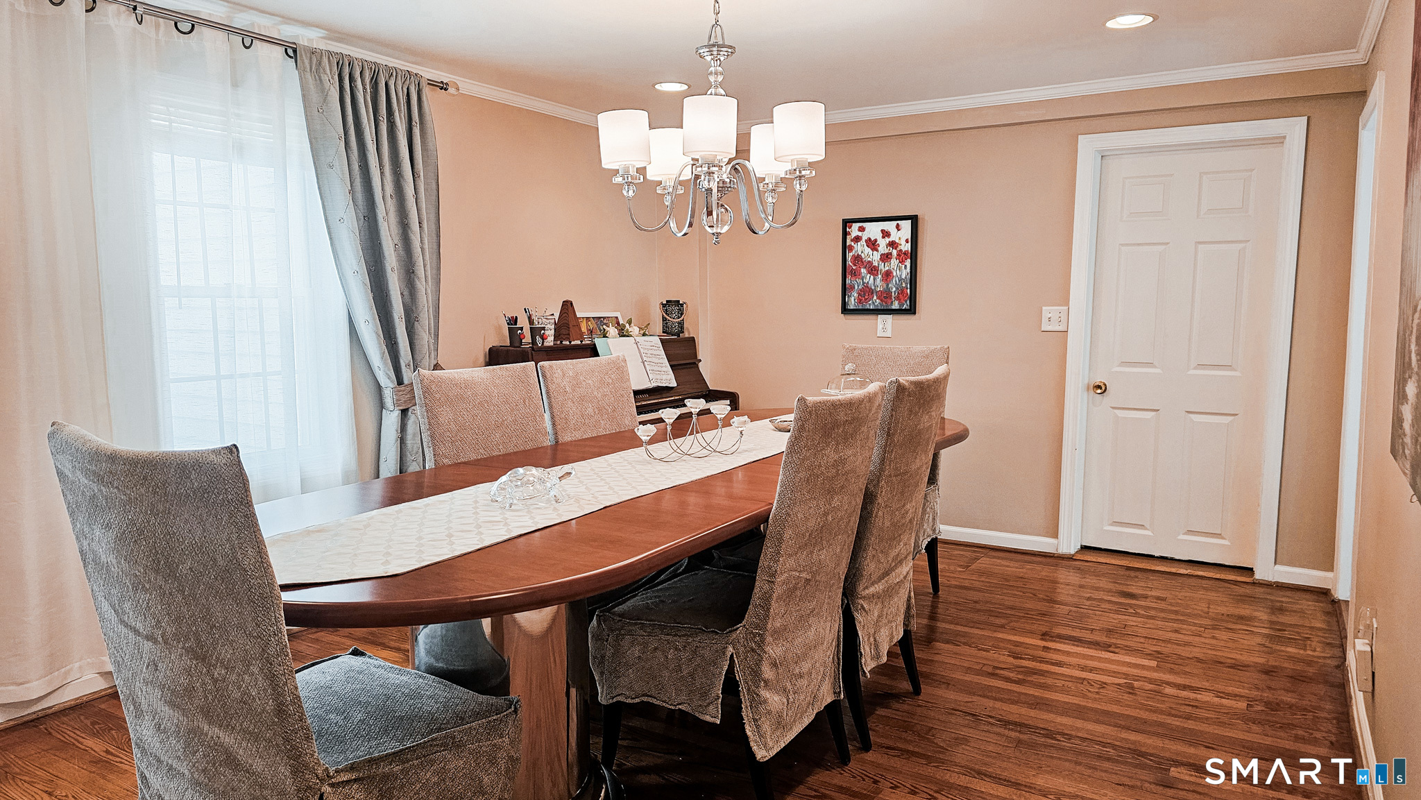 384 Long Hill Road South Windsor, CT 06074 - Photo 12 of 40 a dining room with furniture a chandelier and wooden floor