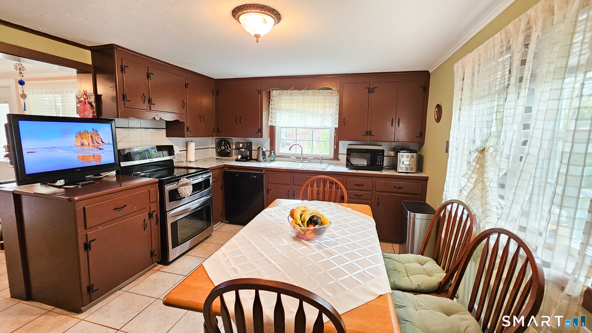 384 Long Hill Road South Windsor, CT 06074 - Photo 17 of 40 a kitchen with stainless steel appliances granite countertop a stove top oven a sink dishwasher and wooden cabinets