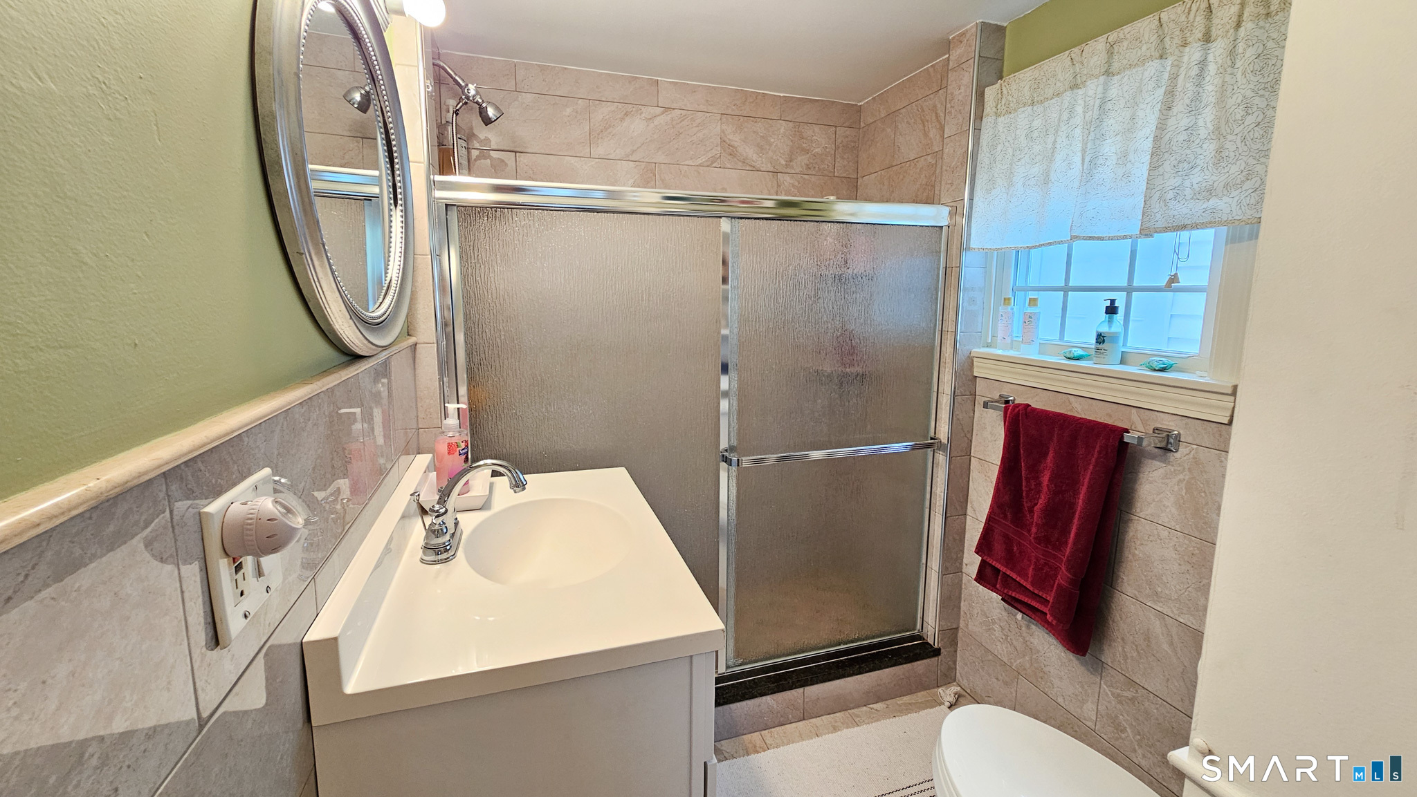 384 Long Hill Road South Windsor, CT 06074 - Photo 20 of 40 a bathroom with a sink a toilet and a mirror
