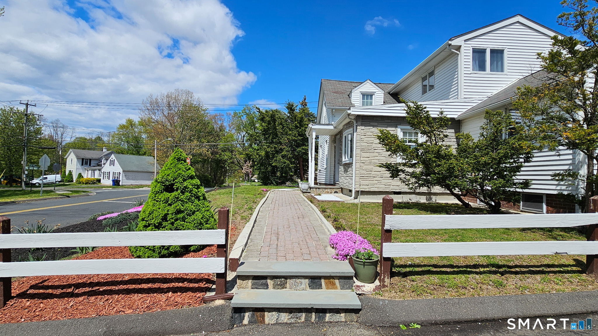 384 Long Hill Road South Windsor, CT 06074 - Photo 2 of 40 a front view of a house with a garden and trees
