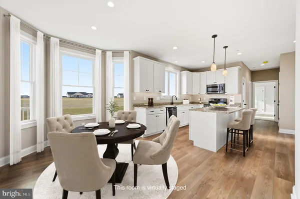 a dining room with furniture a window and kitchen view