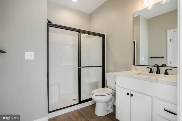 a bathroom with a toilet sink and a mirror