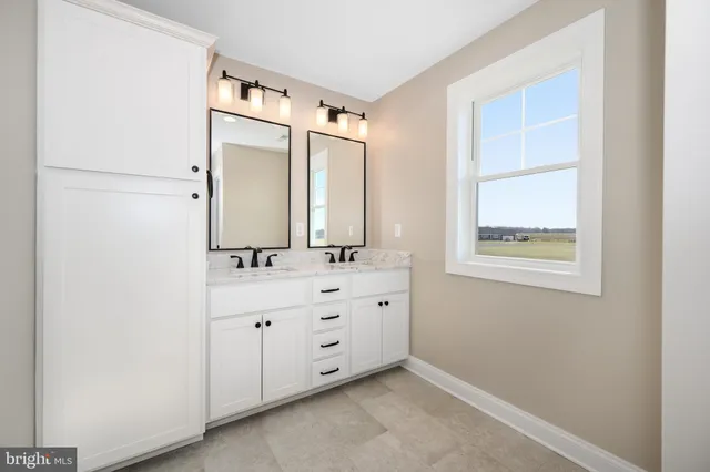 a bathroom with a double vanity sink and mirror