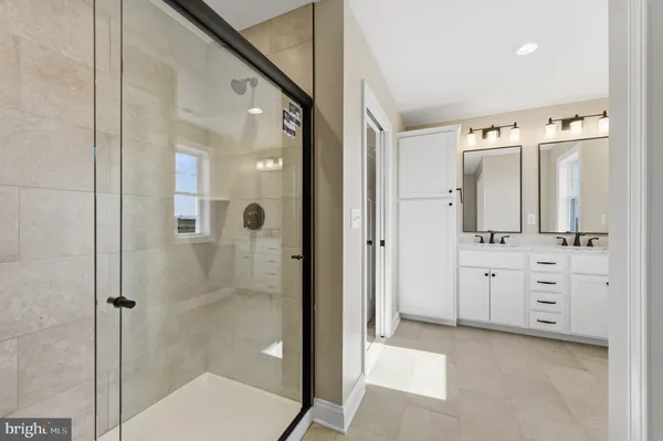 a bathroom with a shower sink and mirror