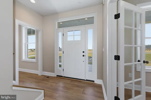 an empty room with windows and entrance