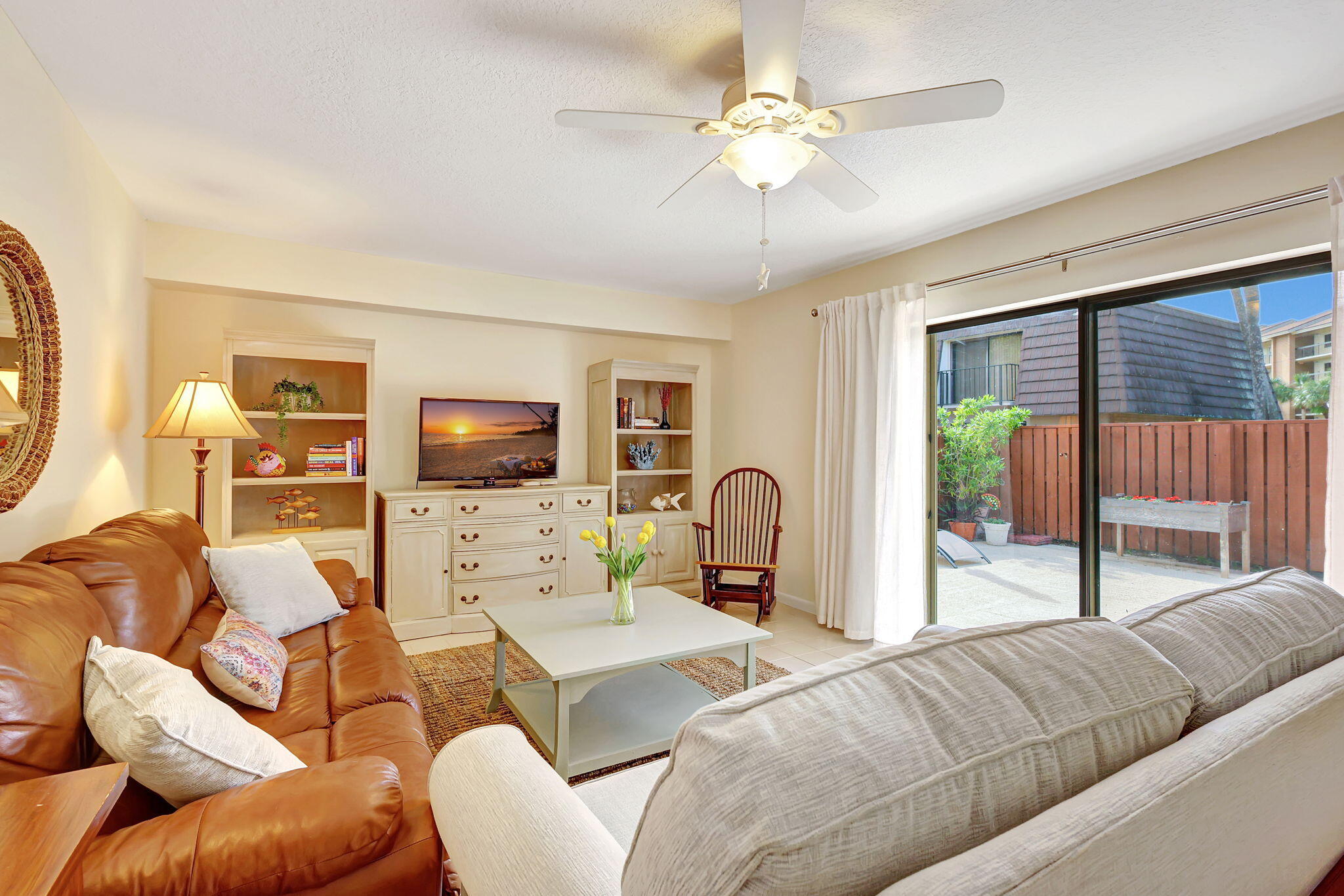 2332 23rd Court, Unit 57D Jupiter, FL 33477 - Photo 1 of 53 a living room with furniture and a flat screen tv