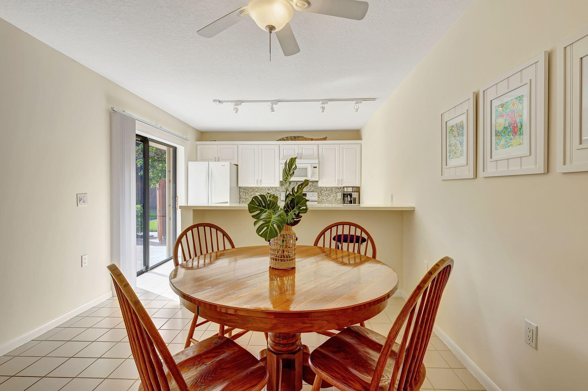 2332 23rd Court, Unit 57D Jupiter, FL 33477 - Photo 12 of 53 a view of a dining room with furniture and wooden floor