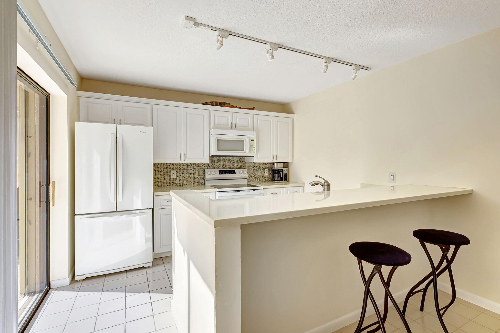 2332 23rd Court, Unit 57D Jupiter, FL 33477 - Photo 13 of 53 a kitchen with stainless steel appliances a refrigerator and a stove top oven