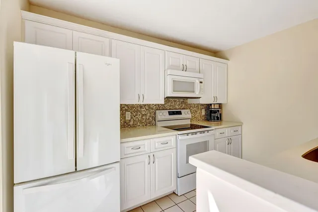 a kitchen with a stove and a refrigerator