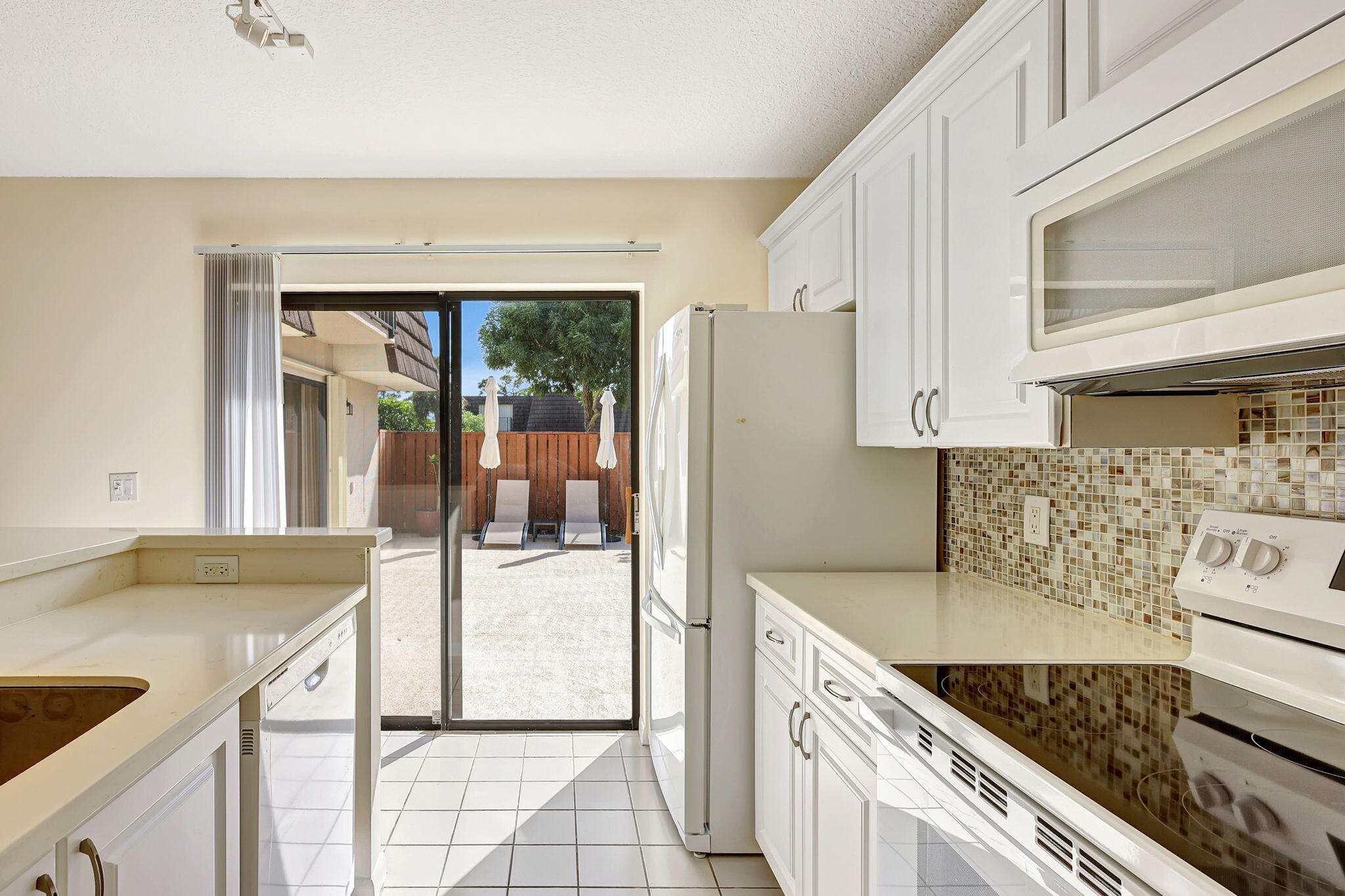 2332 23rd Court, Unit 57D Jupiter, FL 33477 - Photo 16 of 53 a kitchen with a stove and a refrigerator