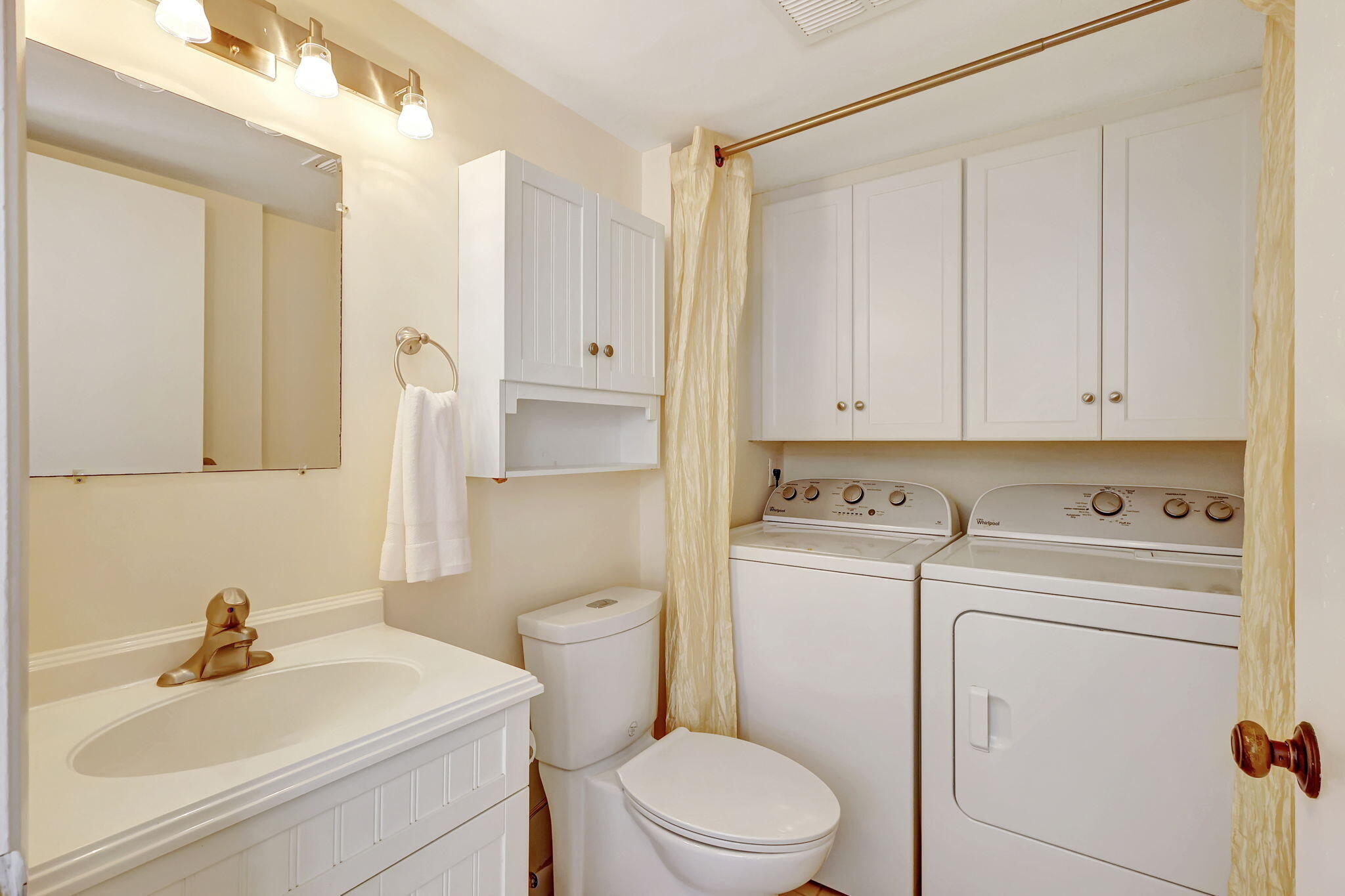 2332 23rd Court, Unit 57D Jupiter, FL 33477 - Photo 19 of 53 a bathroom with a sink a toilet and a mirror