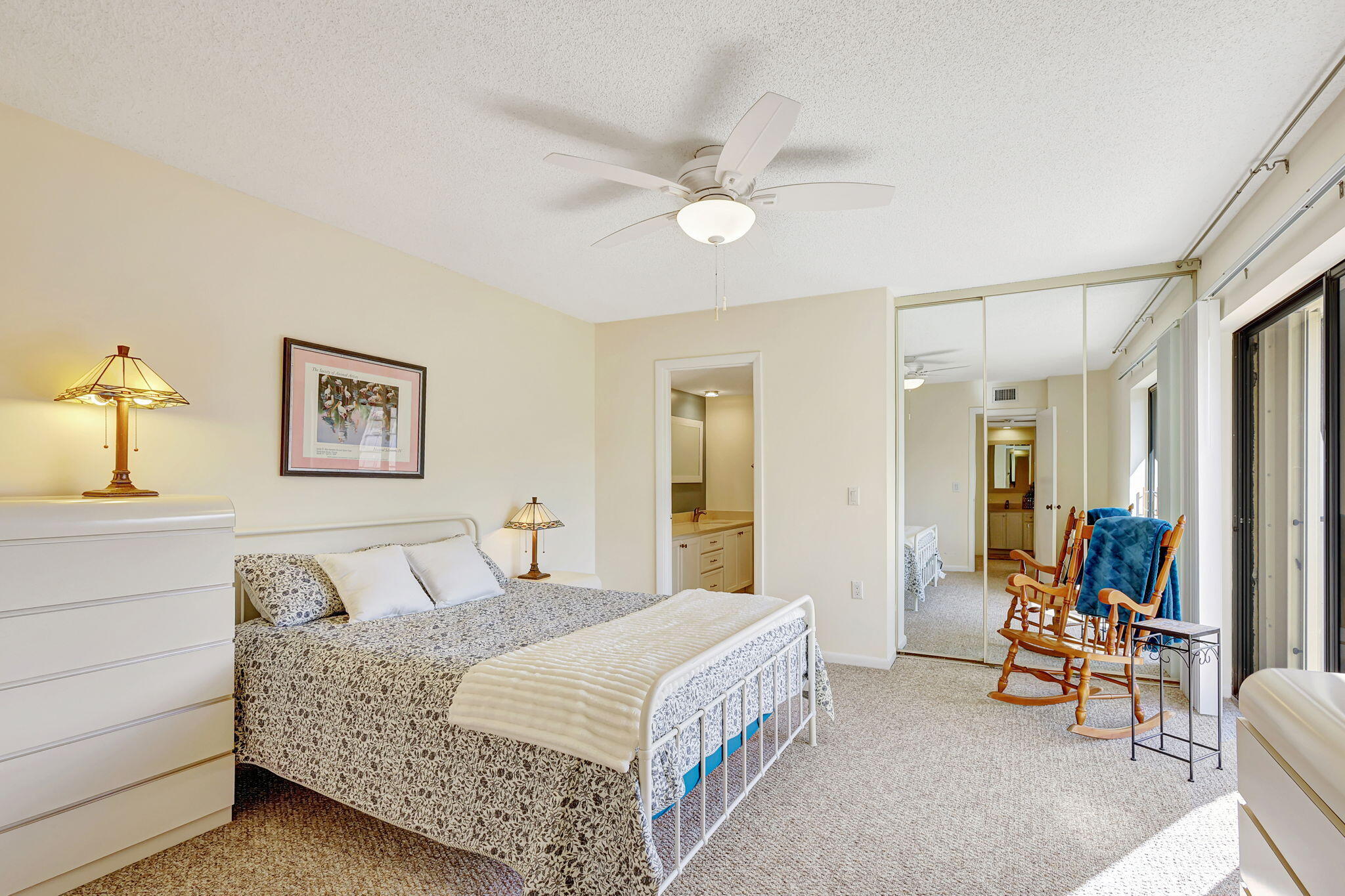 2332 23rd Court, Unit 57D Jupiter, FL 33477 - Photo 22 of 53 a bedroom with a bed and a chandelier