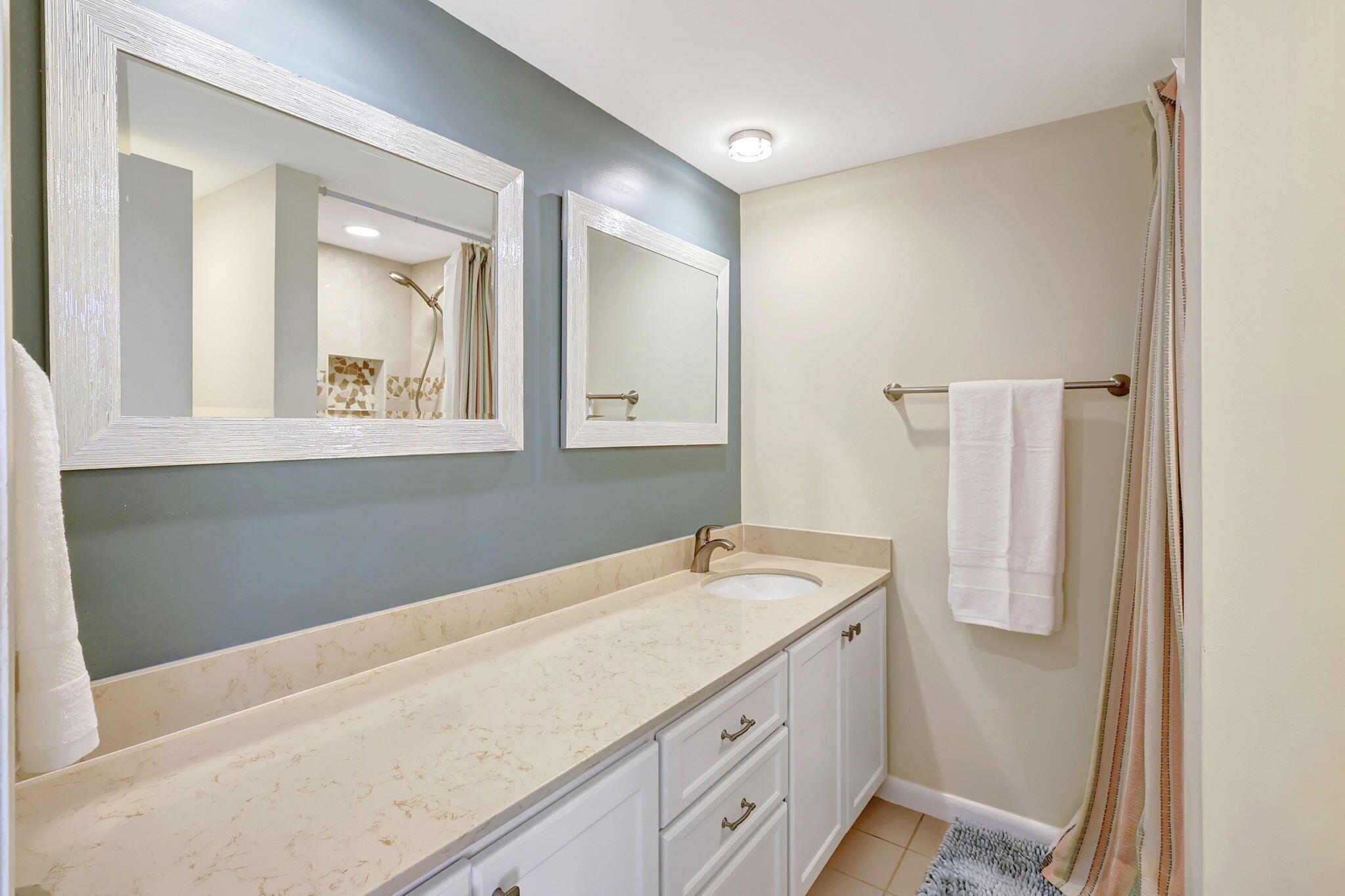 2332 23rd Court, Unit 57D Jupiter, FL 33477 - Photo 23 of 53 a bathroom with a granite countertop sink and a mirror