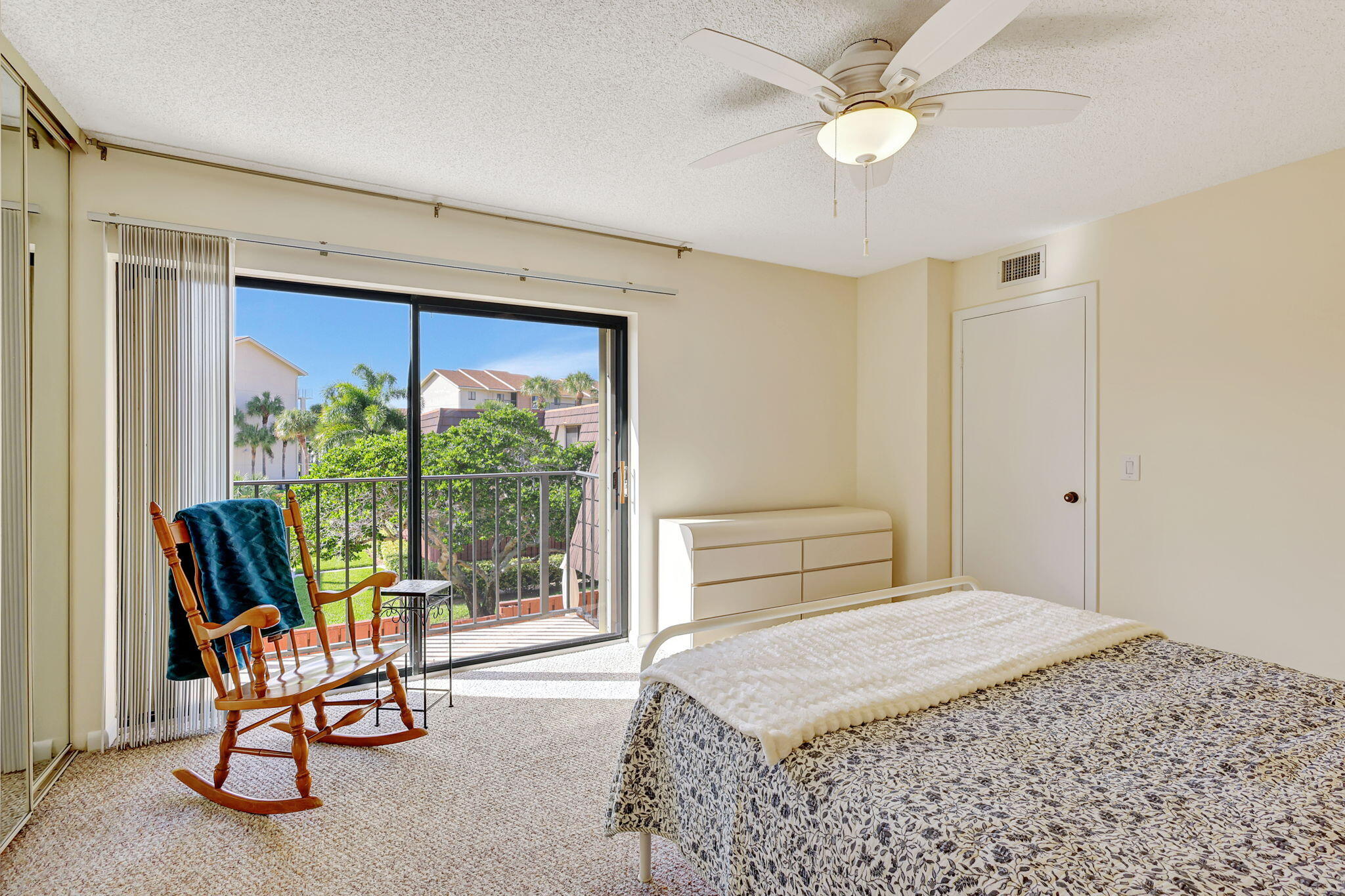 2332 23rd Court, Unit 57D Jupiter, FL 33477 - Photo 25 of 53 a bedroom with a bed and a large window