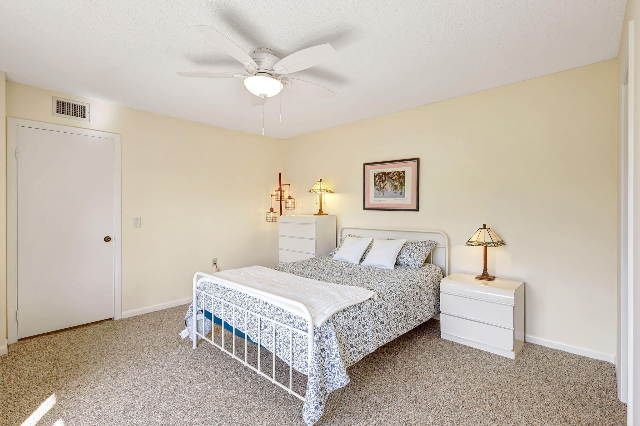 2332 23rd Court, Unit 57D Jupiter, FL 33477 - Photo 28 of 53 a bedroom with a bed and a chandelier