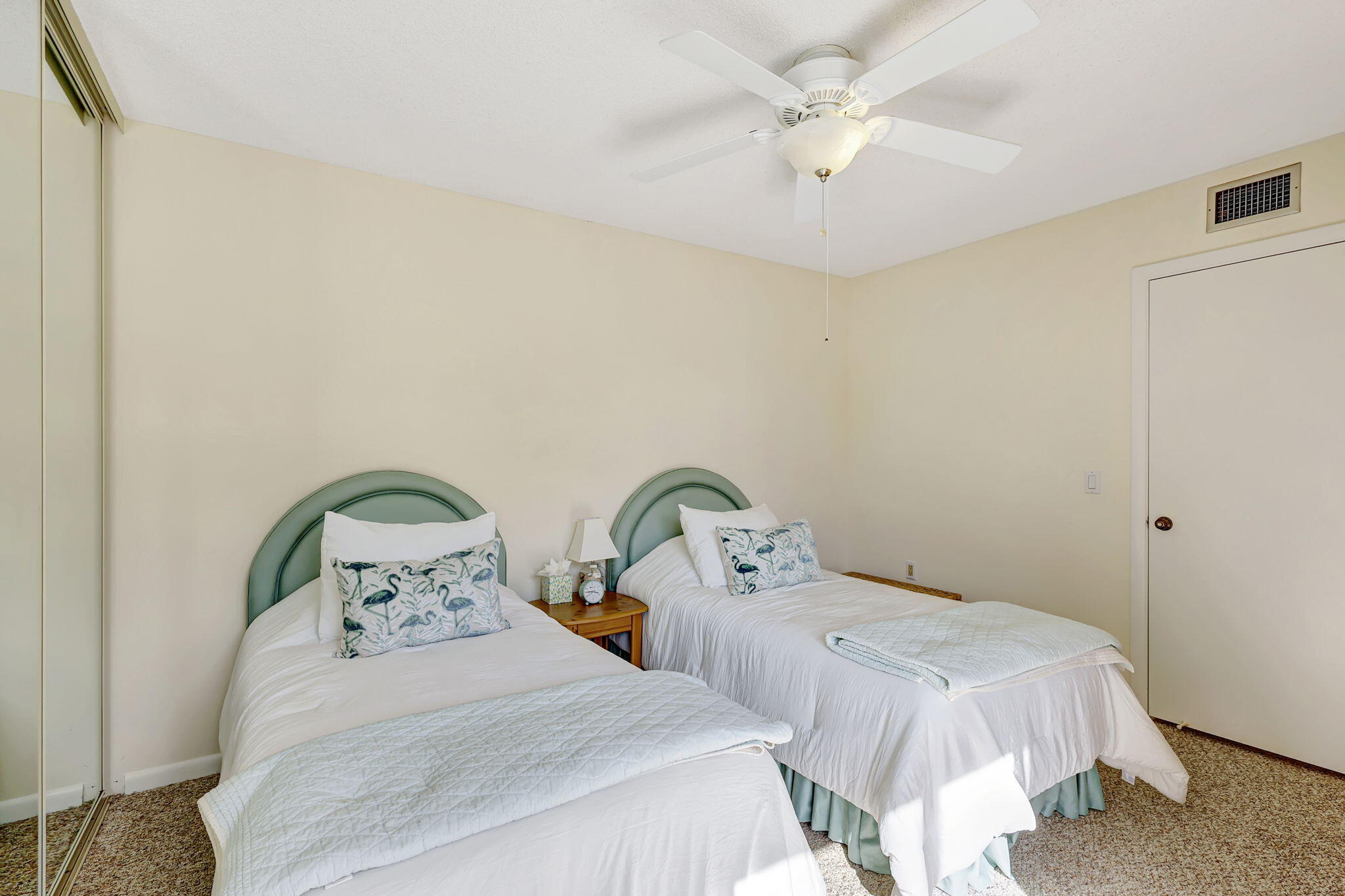 2332 23rd Court, Unit 57D Jupiter, FL 33477 - Photo 31 of 53 a bedroom with two beds and a chandelier