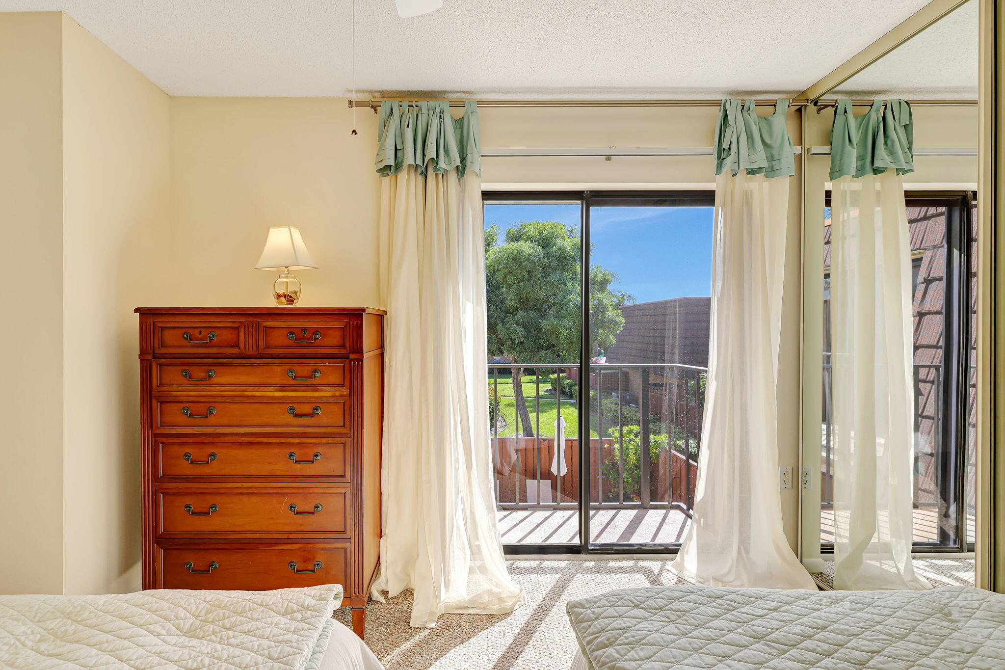 2332 23rd Court, Unit 57D Jupiter, FL 33477 - Photo 32 of 53 a bedroom with a bed and a dresser