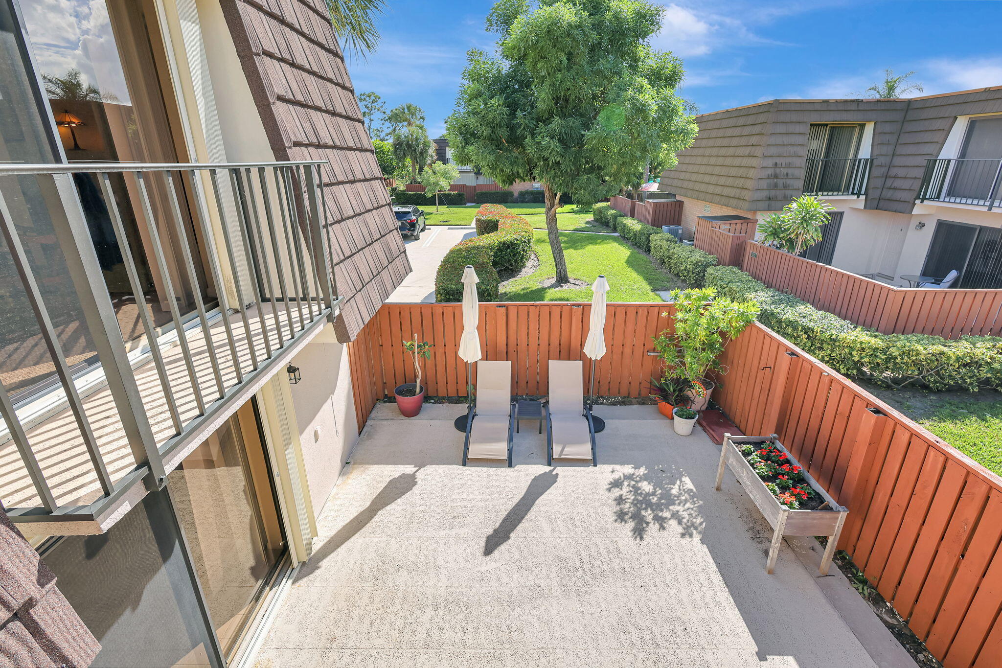 2332 23rd Court, Unit 57D Jupiter, FL 33477 - Photo 33 of 53 a view of balcony with wooden floor outdoor seating and stairs
