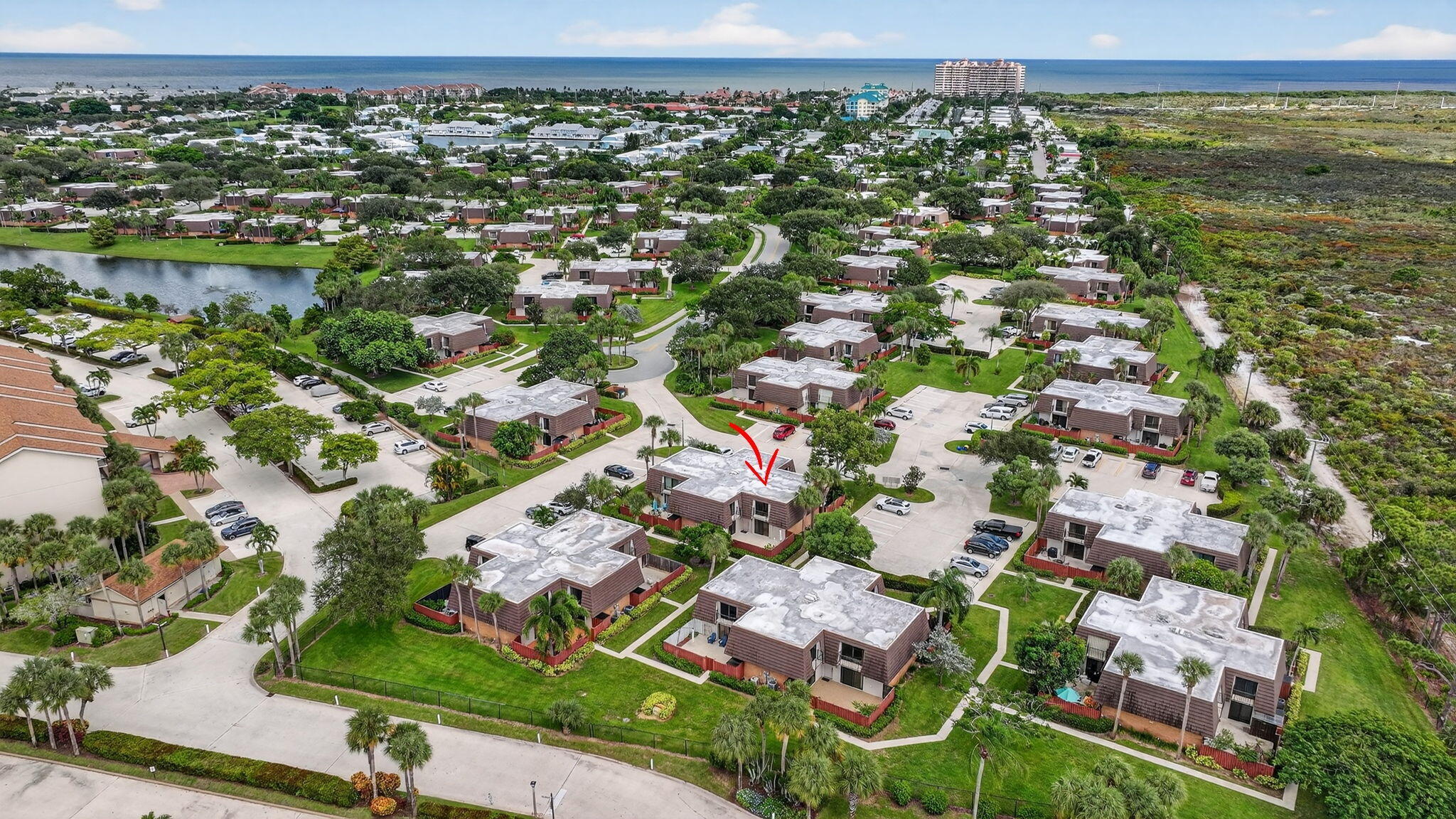 2332 23rd Court, Unit 57D Jupiter, FL 33477 - Photo 37 of 53 an aerial view of residential houses with outdoor space and trees