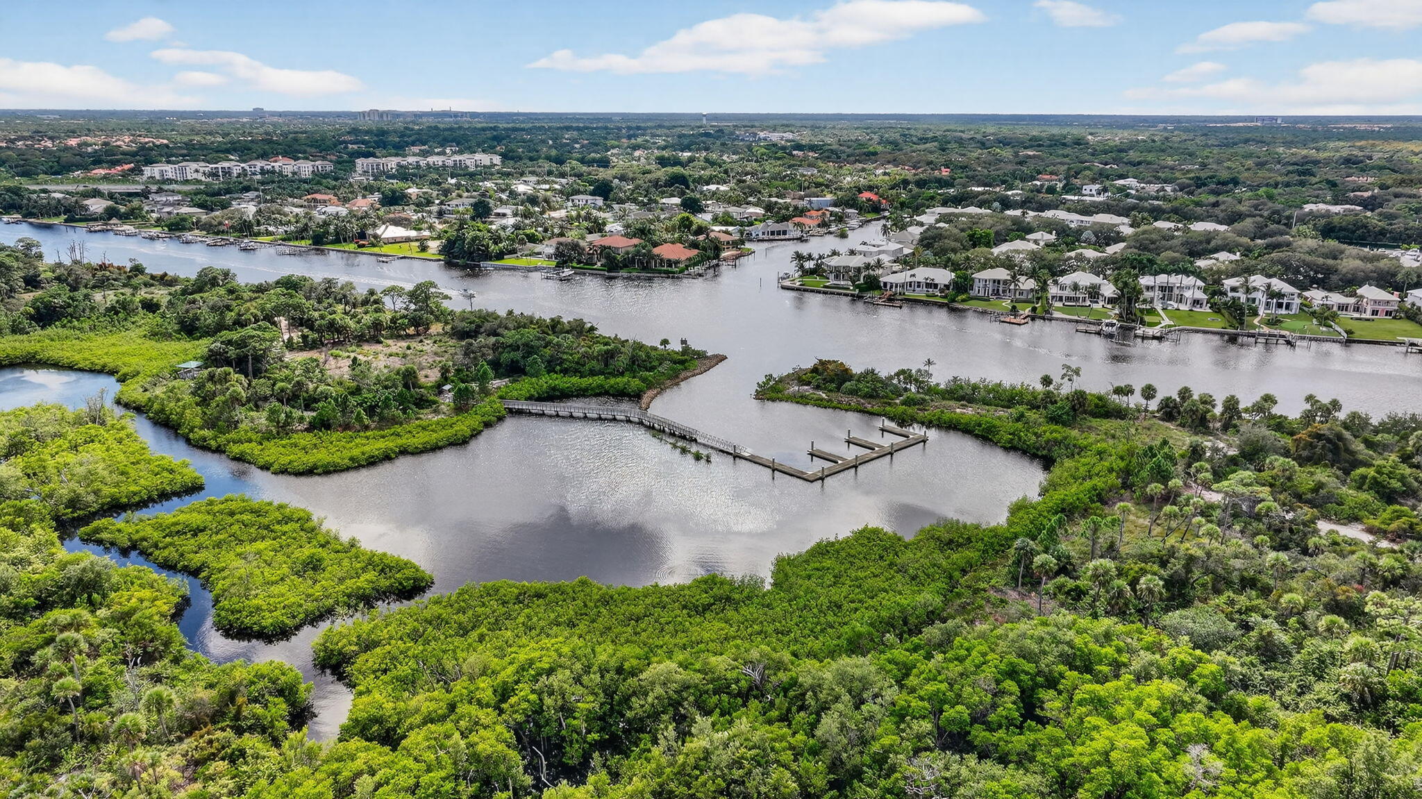 2332 23rd Court, Unit 57D Jupiter, FL 33477 - Photo 47 of 53 an aerial view of city and lake with trees