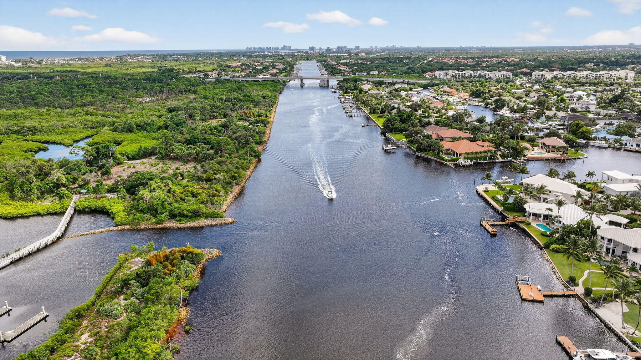 2332 23rd Court, Unit 57D Jupiter, FL 33477 - Photo 48 of 53 an aerial view of a house with a garden and lake view