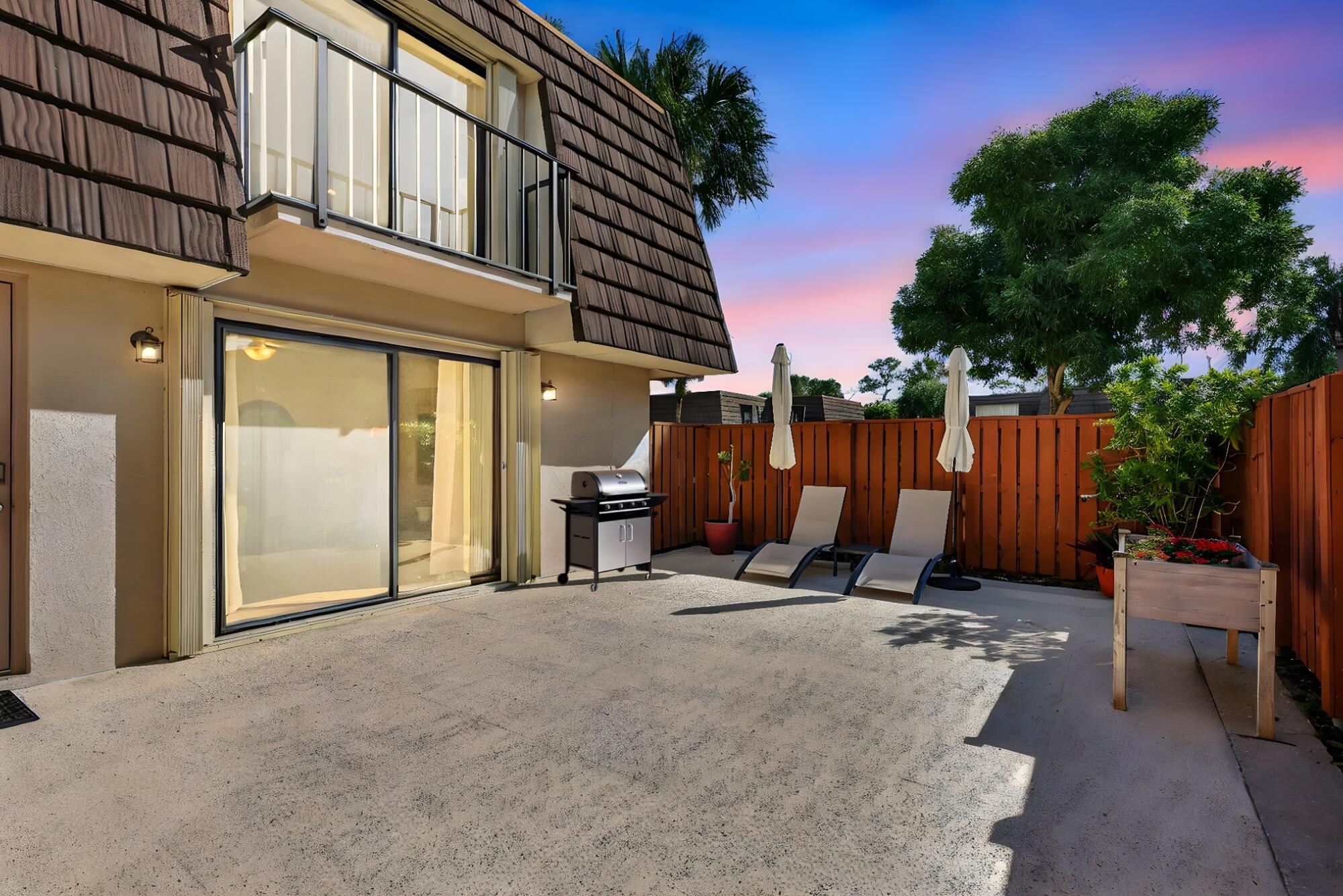 2332 23rd Court, Unit 57D Jupiter, FL 33477 - Photo 52 of 53 a view of a chairs with roof and wooden fence