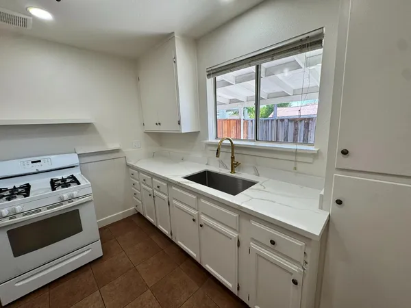 a kitchen that has a sink and a stove