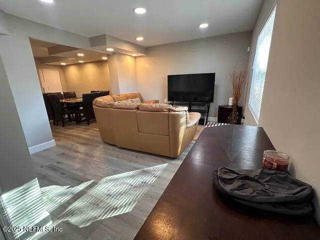 a living room with furniture and a flat screen tv