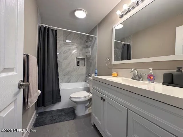 a bathroom with a granite countertop sink mirror vanity and toilet