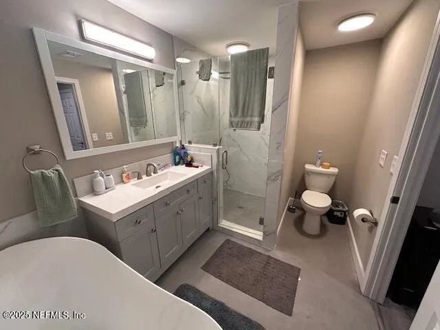 a bathroom with a double vanity sink mirror and toilet