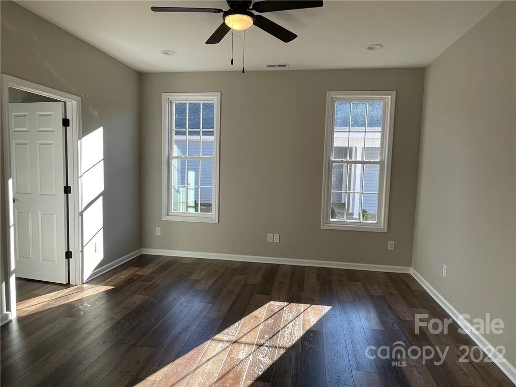 152 Eagles Landing Morganton, NC 28655 - Photo 12 of 27 a view of an empty room with wooden floor and a window