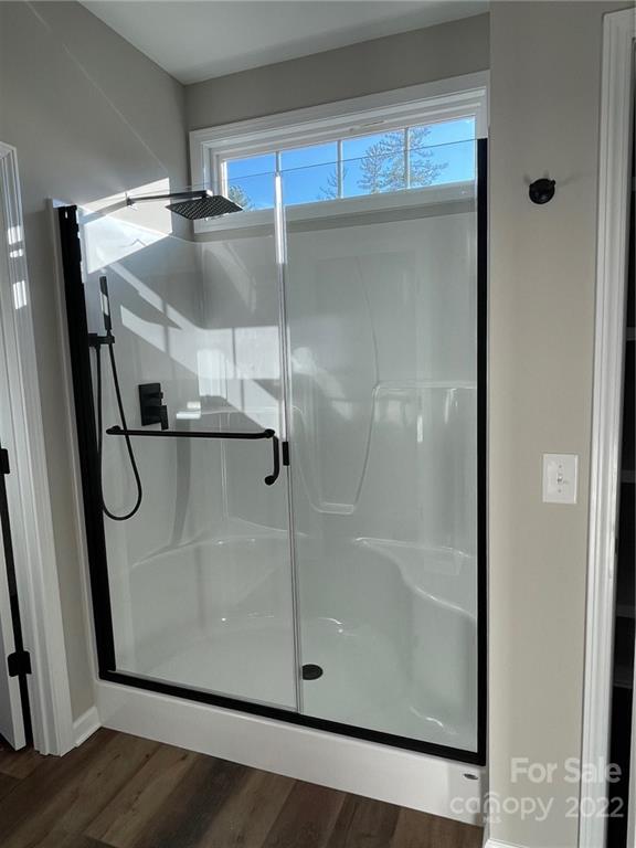 152 Eagles Landing Morganton, NC 28655 - Photo 14 of 27 a bathroom with a glass shower door