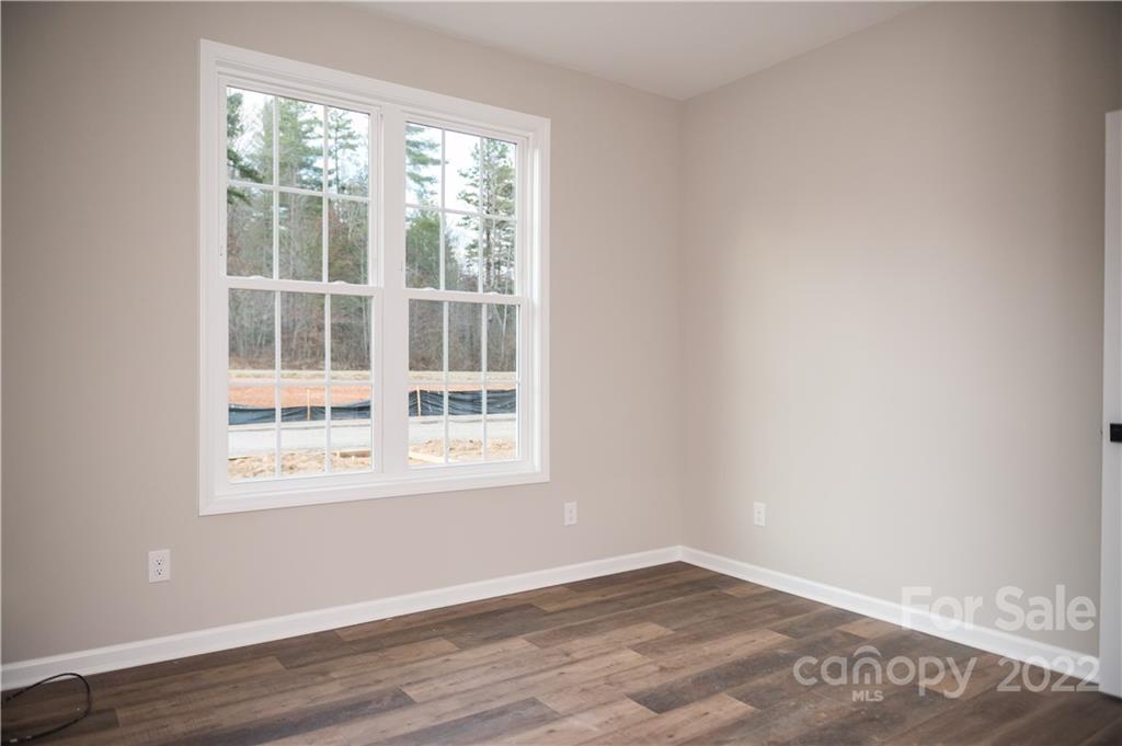 152 Eagles Landing Morganton, NC 28655 - Photo 18 of 27 a view of an empty room with wooden floor and a window