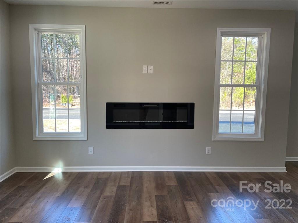 152 Eagles Landing Morganton, NC 28655 - Photo 7 of 27 an empty room with wooden floor and windows