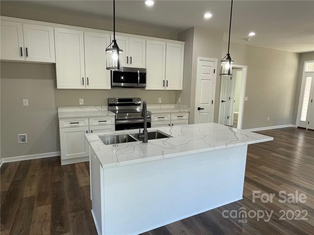 152 Eagles Landing Morganton, NC 28655 - Photo 10 of 27 a kitchen with stainless steel appliances a stove a sink a refrigerator a center island and cabinets