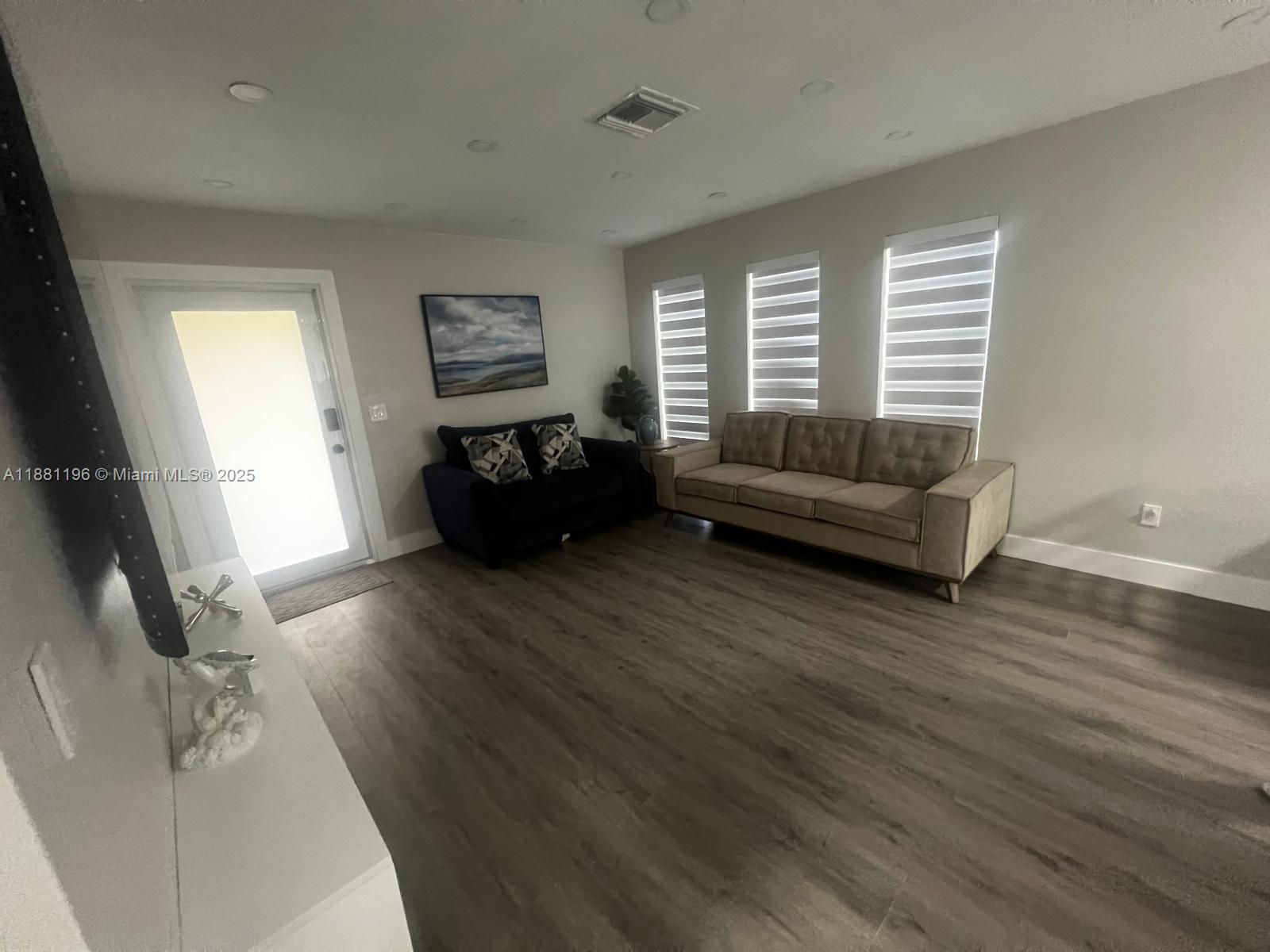 222 Southwest 8th Street, Unit A Dania Beach, FL 33004 - Photo 2 of 16 a living room with furniture and a wooden floor