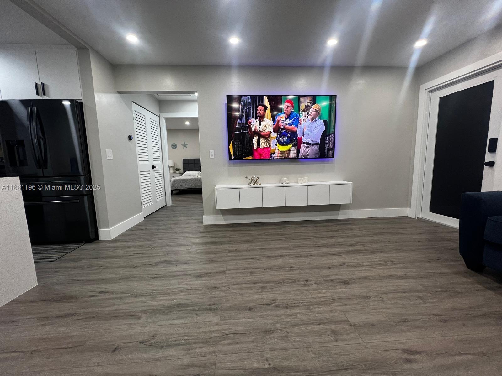 222 Southwest 8th Street, Unit A Dania Beach, FL 33004 - Photo 5 of 16 a view of a projector room with flat screen tv