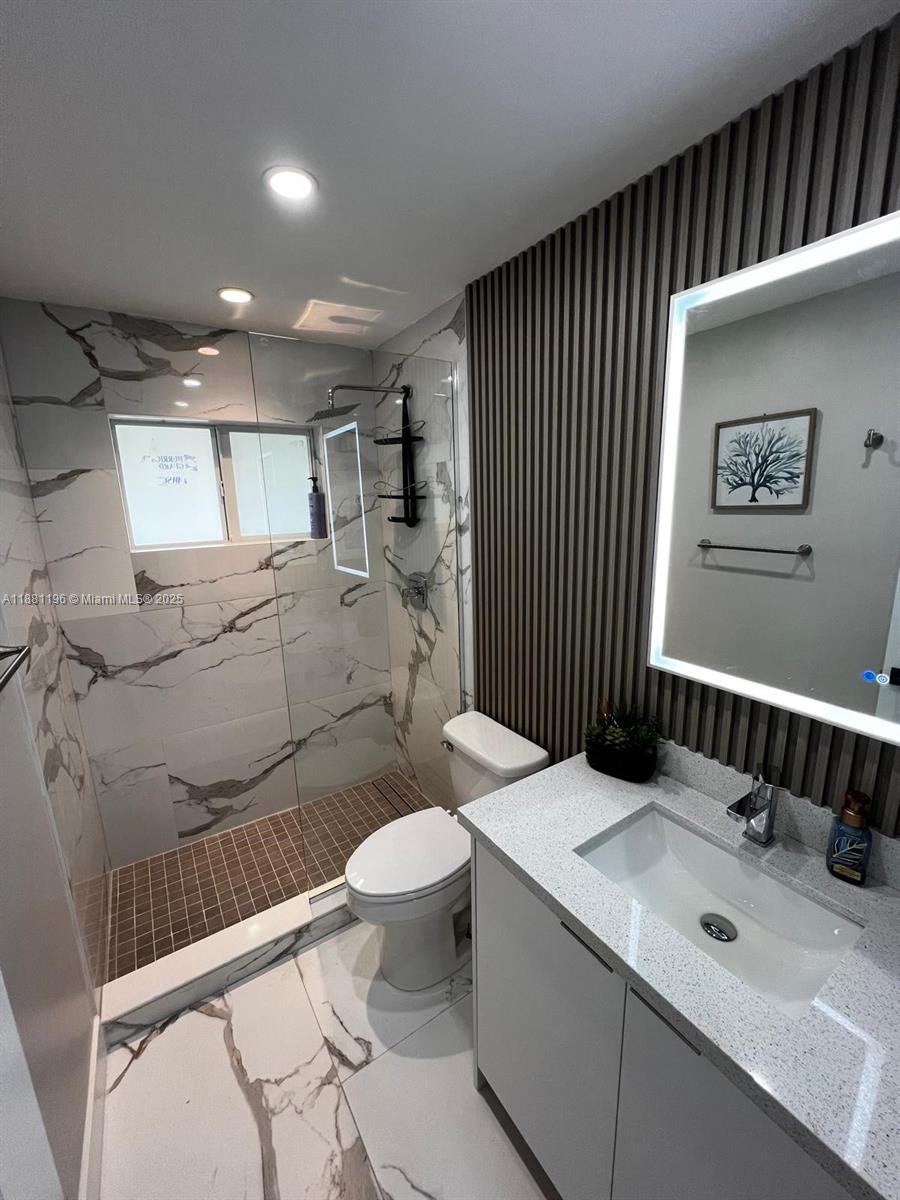 222 Southwest 8th Street, Unit A Dania Beach, FL 33004 - Photo 9 of 16 a bathroom with a sink toilet and shower