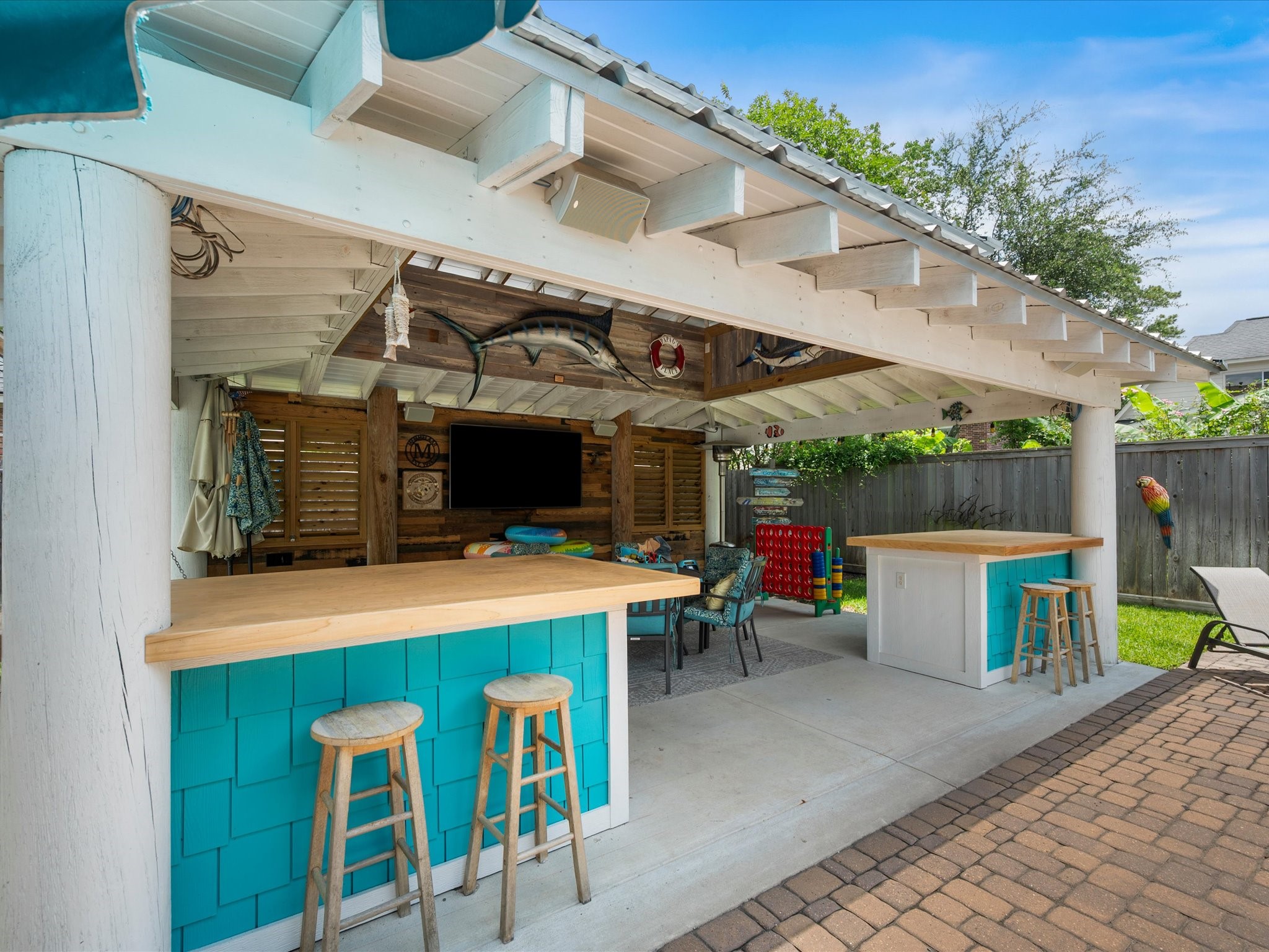 5910 Center Ct Drive Spring, TX 77379 - Photo 42 of 50 A convenient pavilion bar offers the perfect spot for a refreshing beverage, while shaded seating and entertainment space make it easy to unwind and enjoy your favorite shows or game days outdoors.