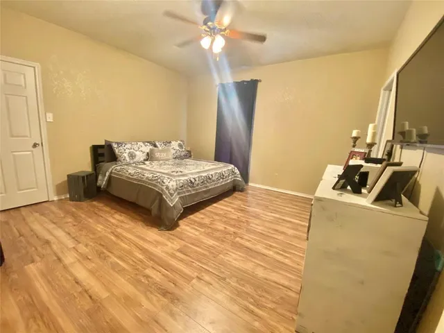a bedroom with a bed and a flat screen tv