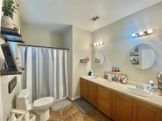 a bathroom with a sink mirror vanity and toilet