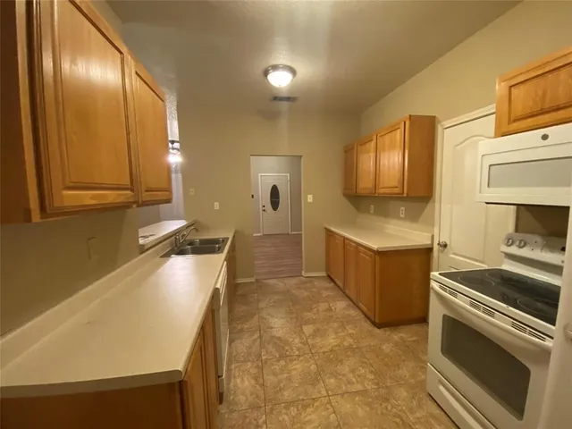 an empty room with a window and ceiling fan