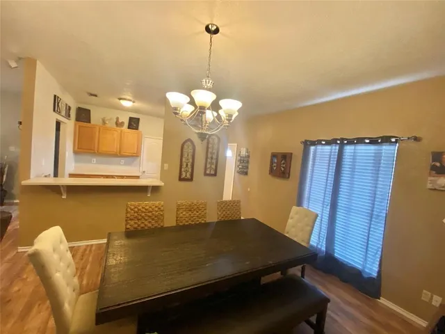 a view of a dining room with furniture and chandelier
