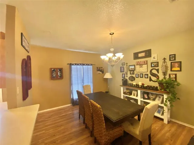 a view of a dining room with furniture and chandelier