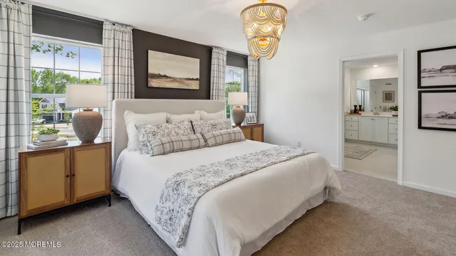 a bedroom with a bed a table and chair