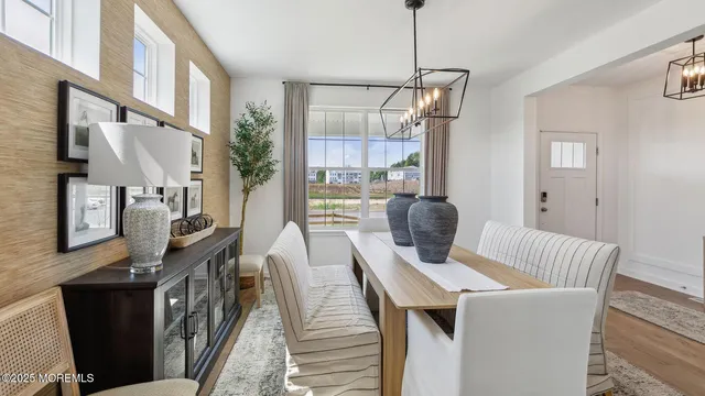 a living room with furniture kitchen area and a wooden floor