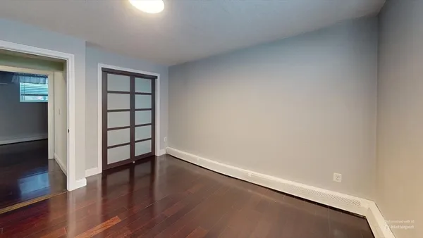 wooden floor in an empty room with a window