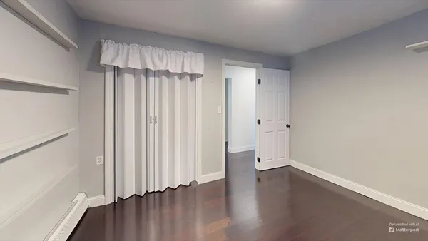 a view of a room with wooden floor